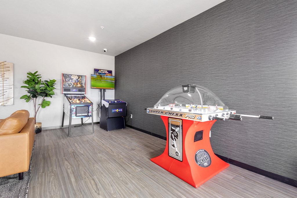 a game room with a large arcade machine in the middle of it