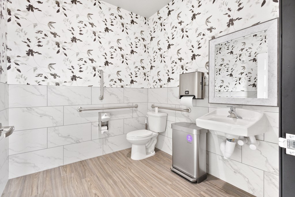 a bathroom with a toilet and a sink and a mirror