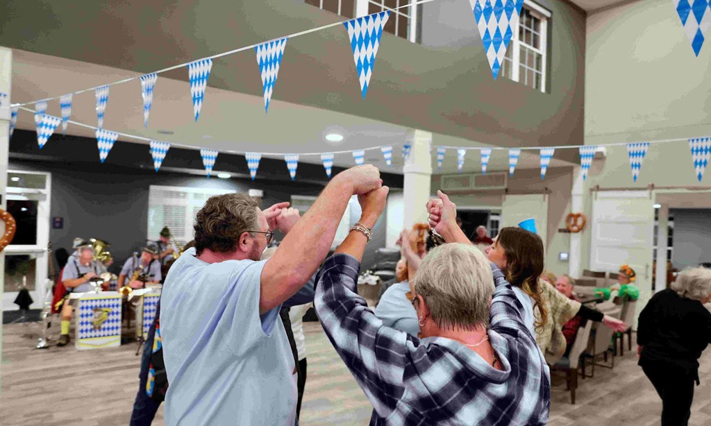 people celebrating at a party with their hands up in the air