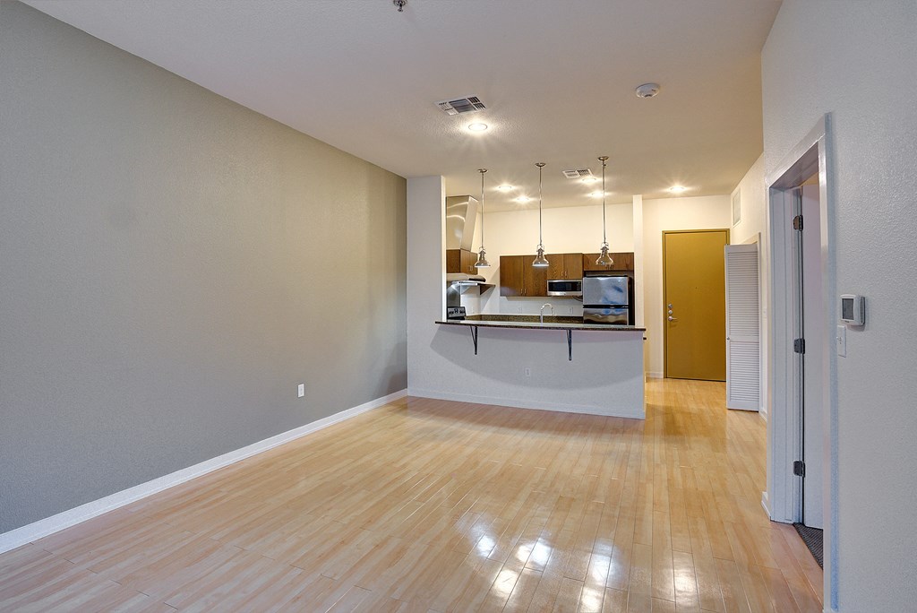 Shiny hardwood floors in organic finishing apartment Living Room at The Mosaic on Broadway, San Antonio, TX, 78215