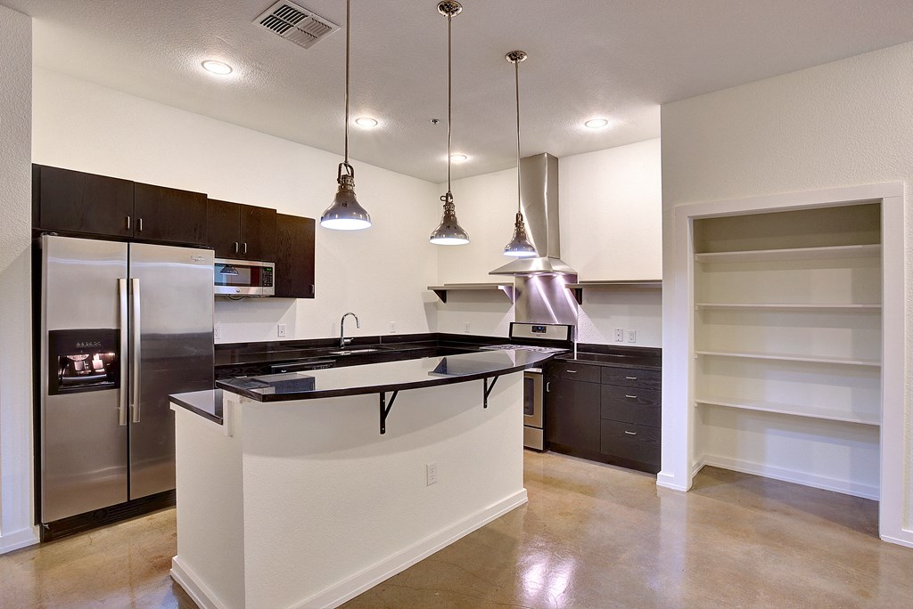 Pendant Accent lighting adds to the industrial feel of the unit at The Mosaic on Broadway, San Antonio, TX