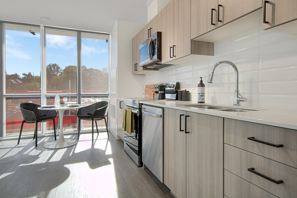 a kitchen with a sink and a table with chairs