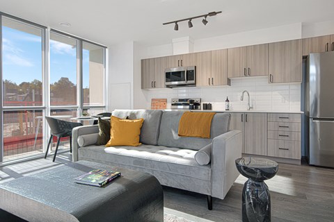 a living room with a couch and a kitchen