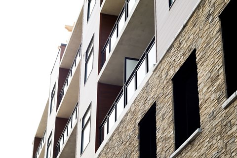 A building with a balcony and windows.