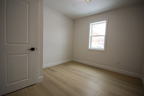 A room with a door and a window.