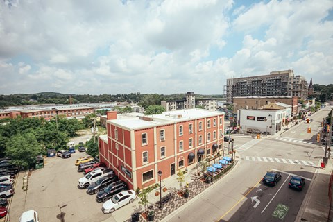 A red building with a parking lot in front of it.