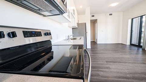 A modern kitchen with a black stove top oven.