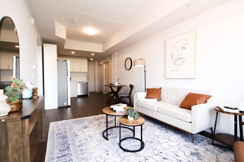 A living room with a white couch and a coffee table.