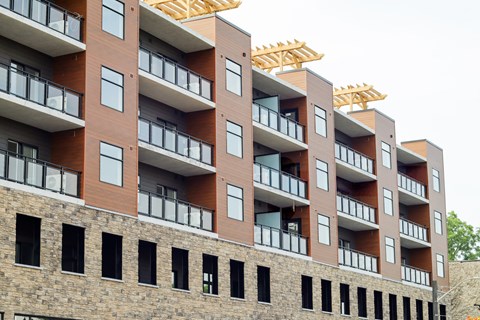 A multi-story building with balconies and windows.