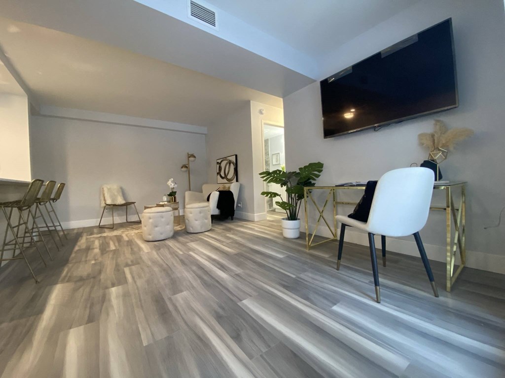 a living room with a tv and a table and chairs
