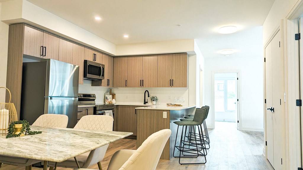 a kitchen and dining area with a table and chairs