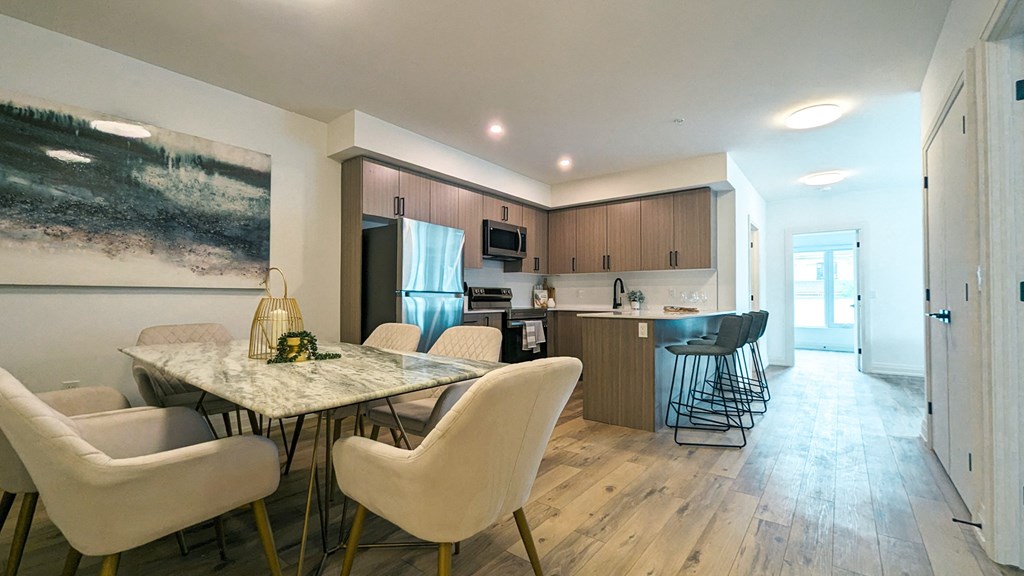 a kitchen and dining room with a table and chairs