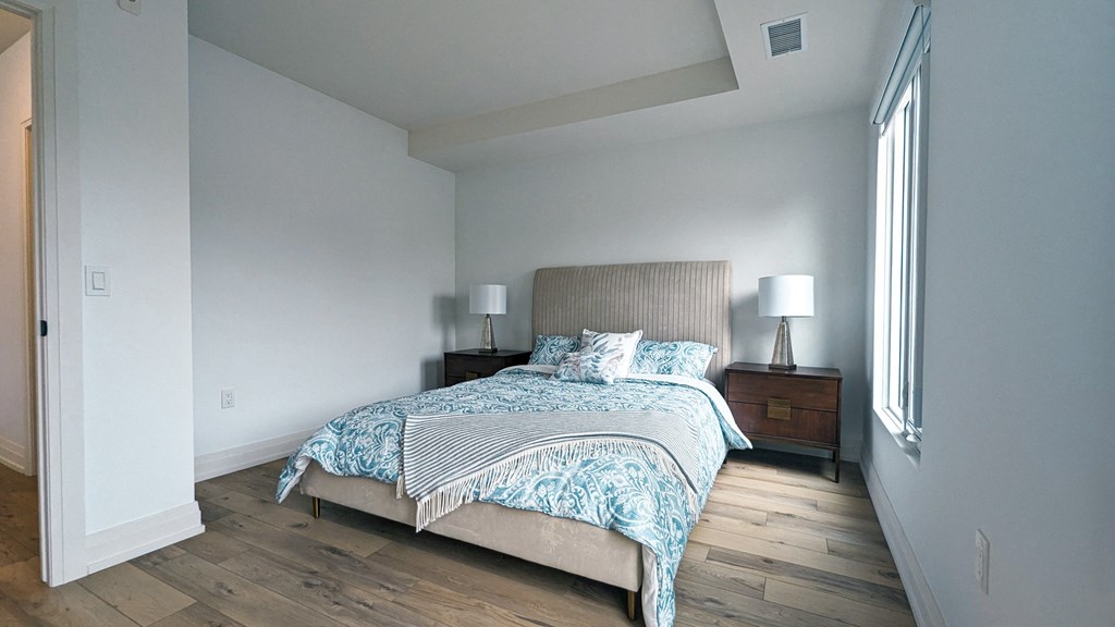 a bedroom with a large bed and a window