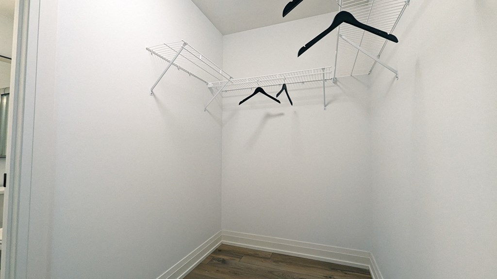 a room with white walls and two wire racks on the wall