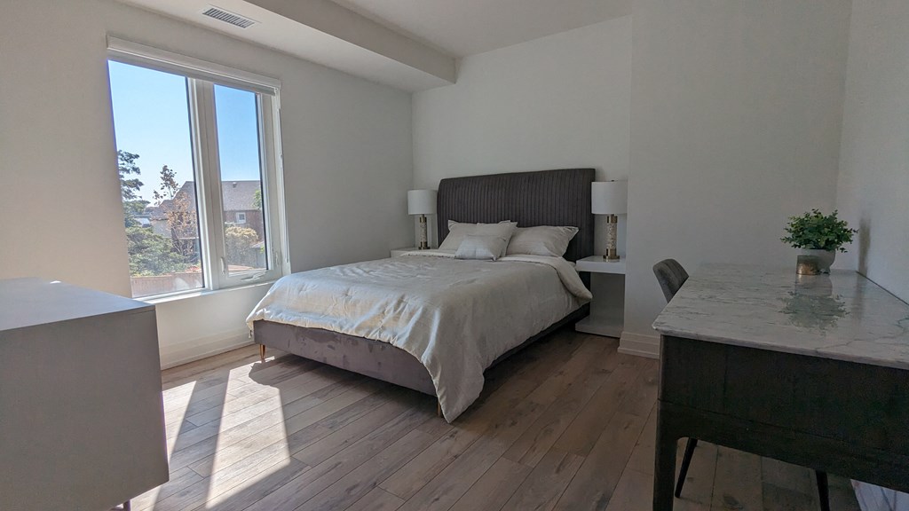 a bedroom with a bed and a large window