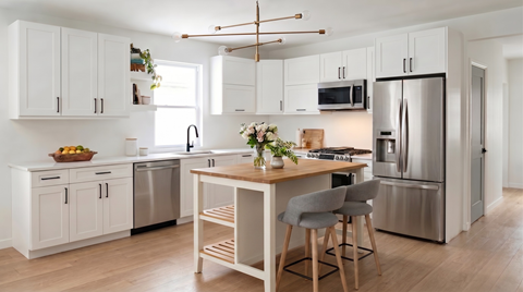 A rendering of the townhouse kitchens, with white cabinets and stainless steel appliances.