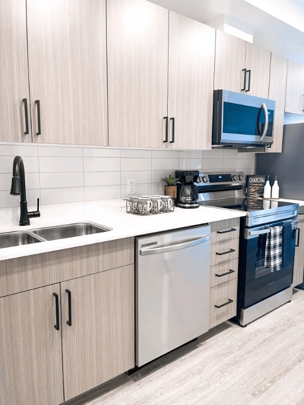 a kitchen with a sink and a stove and a microwave