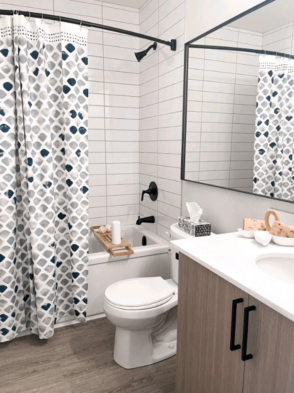 a white bathroom with a shower curtain and a toilet
