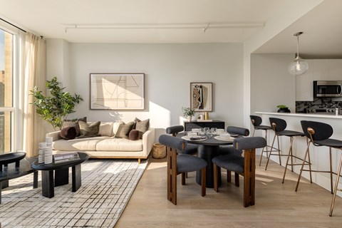 A modern living room with a dining table set for four.
