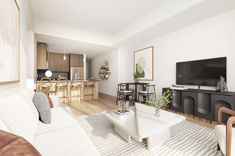 A living room with a white couch and a television.