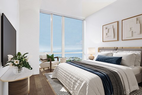 bedroom with floor to ceiling windows and water views
