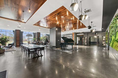 A modern dining area with a long table and chairs.