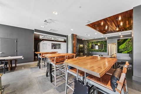 A modern dining room with a long wooden table and chairs.