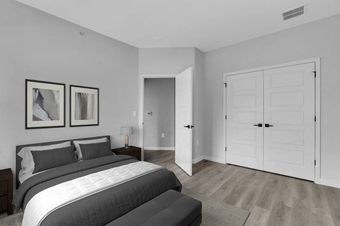A bedroom with a large bed and two framed pictures on the wall.