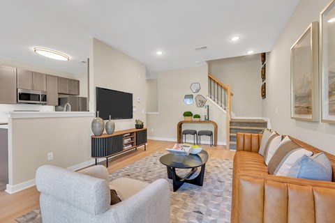 A living room with a grey couch and a black coffee table.