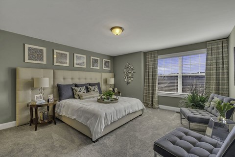 Interior Photo of the model at Princeton Terrace at West Windsor showing a bedroom with bed%2c night stand and dresser with wall to wall carpeting. Large double window to allow for natural light.