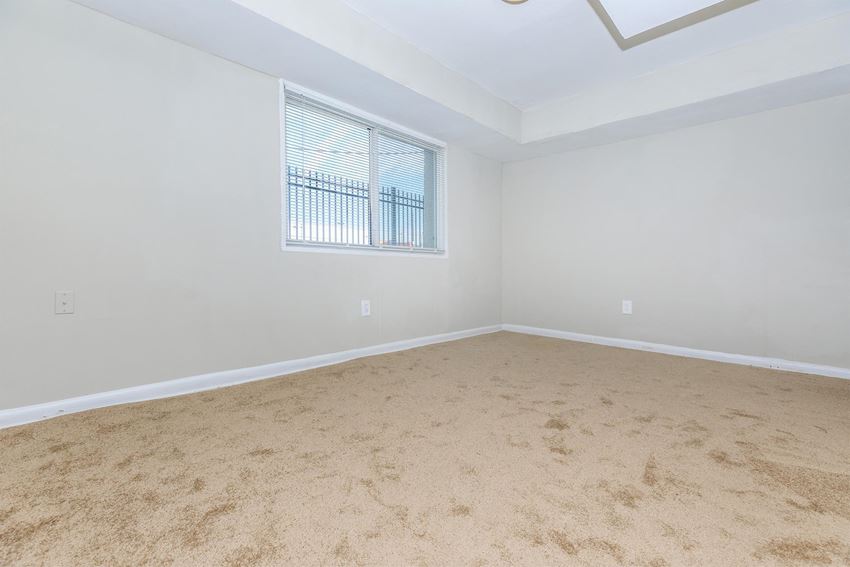 a bedroom with beige carpet and a window a bedroom with beige carpet and a window at Regency Court, Maryland - Photo Gallery