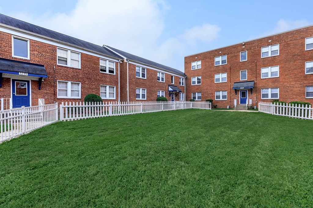 a large green lawn in front of a brick building at Highland Ridge, Capitol Heights, 20743