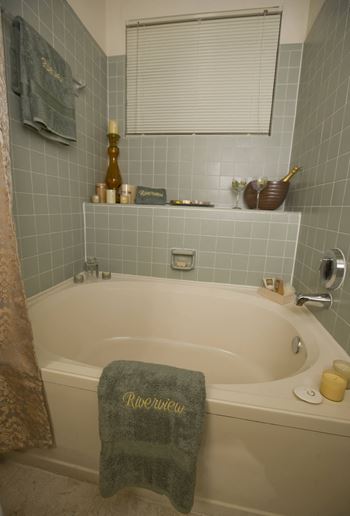 a bathroom with a bathtub and a towel on the edge of the tub