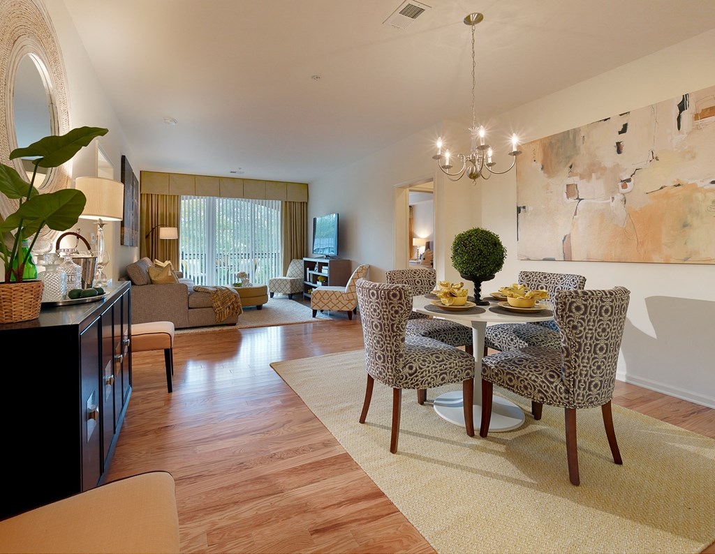 a dining room and living room with a table and chairs