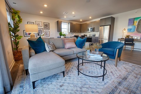 A living room with a grey couch and a blue chair.