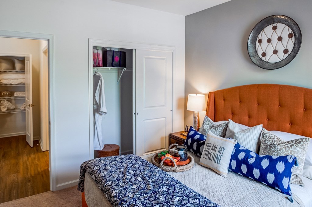 a bedroom with a bed with blue and white pillows