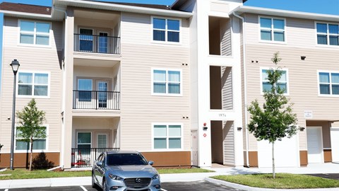 Exterior view of warm, homey 3 storey apartment building