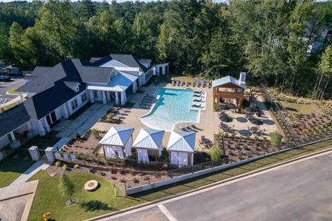 A large building with a pool in front of it.