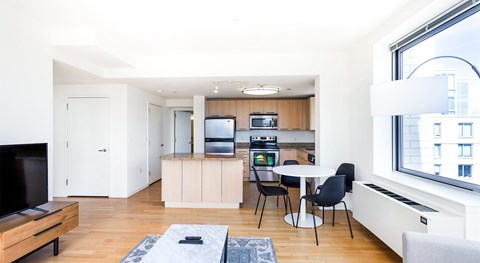 A modern kitchen with a dining table and chairs.