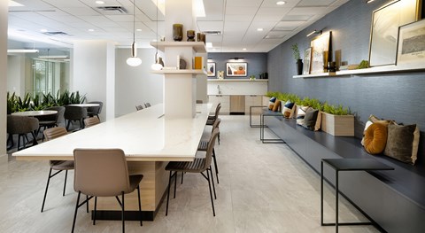 A modern conference room with a long table and chairs.