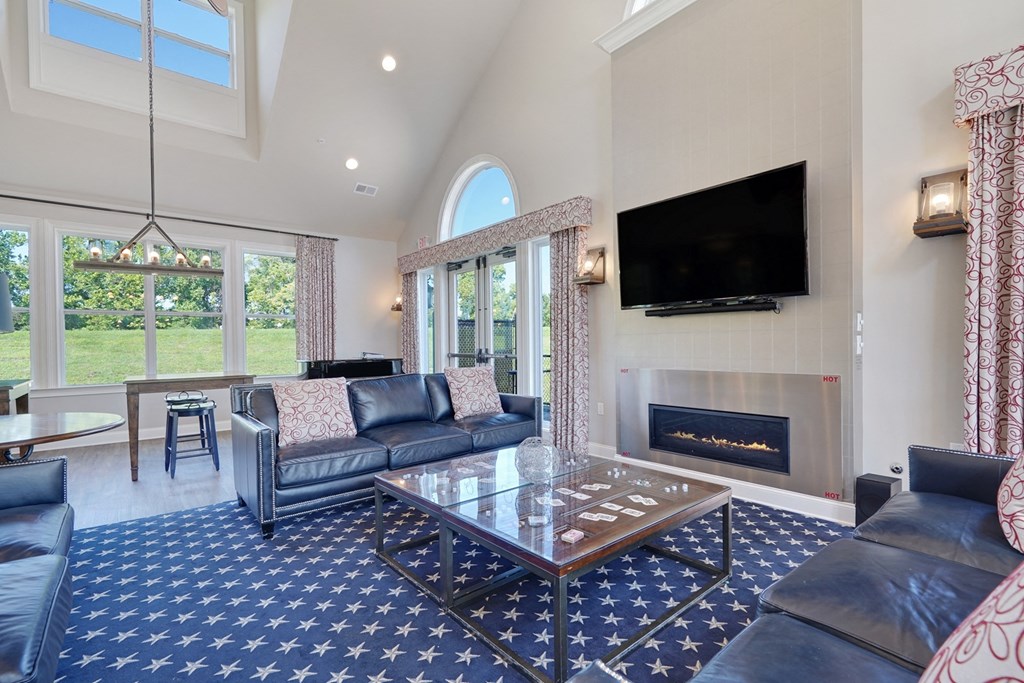 a living room with couches and a coffee table and a fireplace