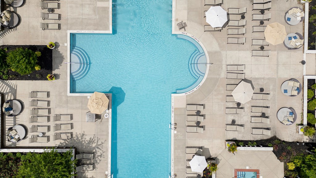 Top-down view of resort-style pool and sun deck at Princeton NJ apartments for rent