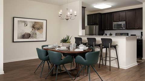 A dining room with a table set for six people.