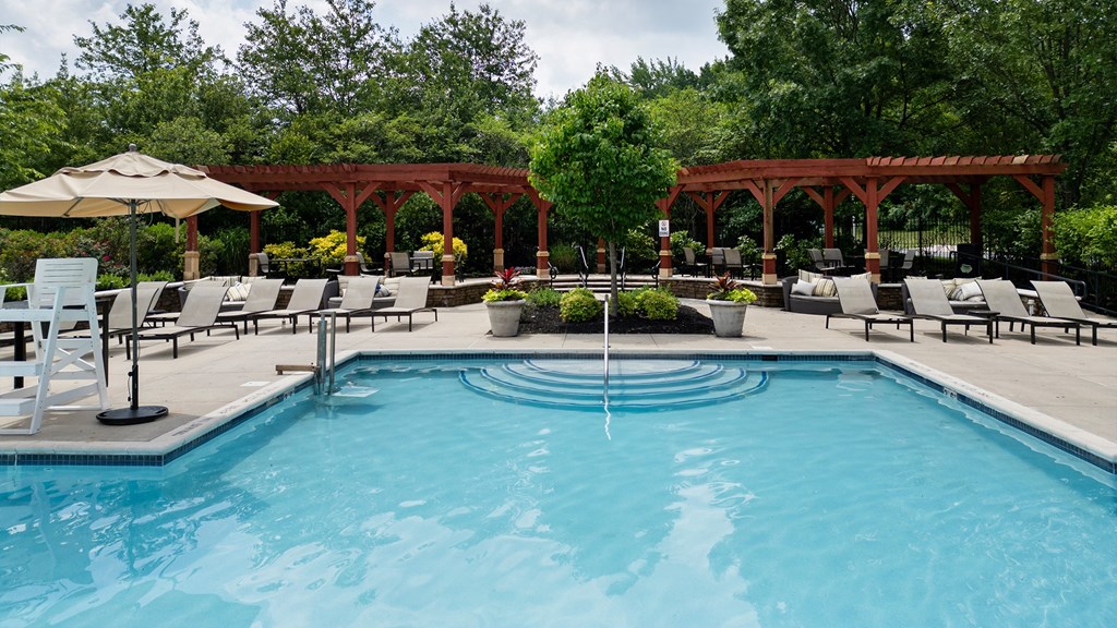 Luxury apartment pool with sun loungers and pergola seating in Princeton New Jersey