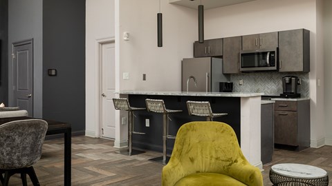 A yellow chair sits in front of a kitchen island.