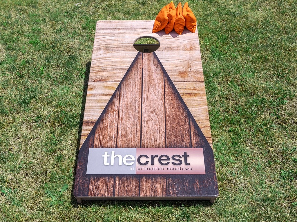 a chopping board with a sign on it on the grass