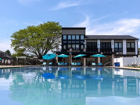 a swimming pool with a building in the background