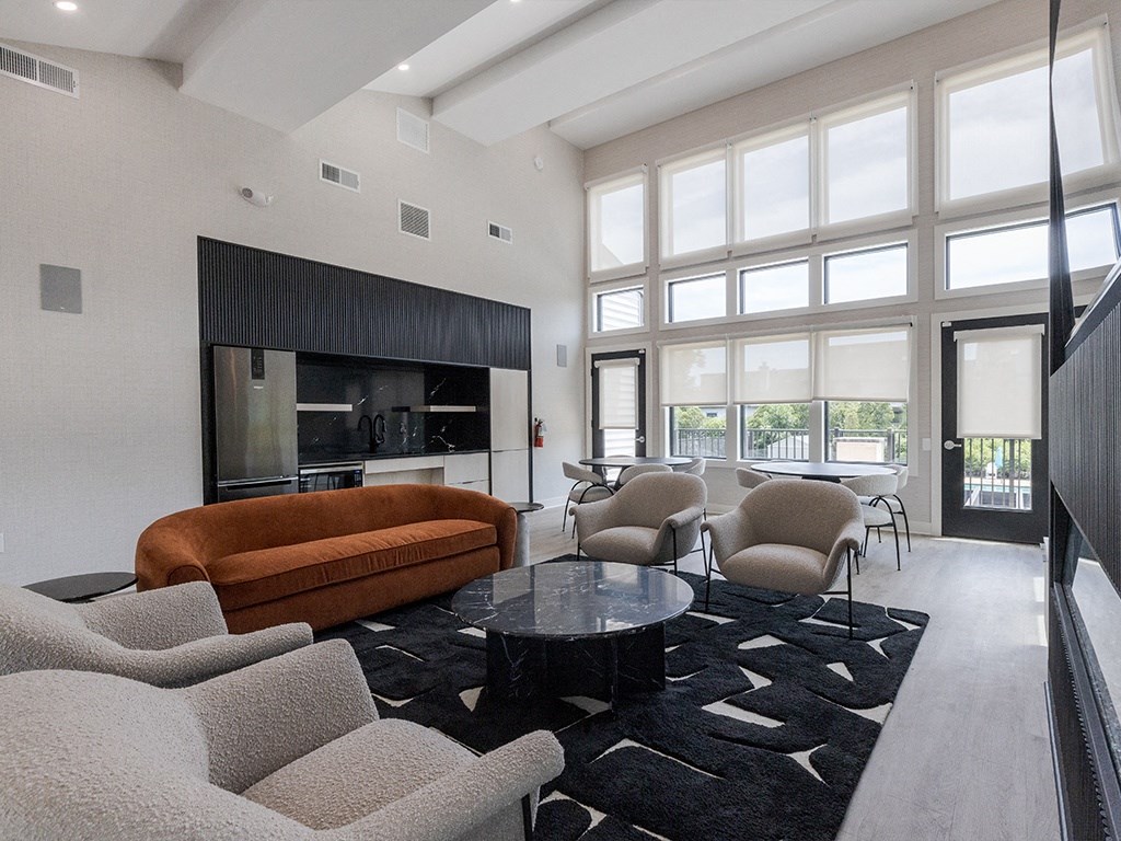 a living room with a couch and chairs and a table