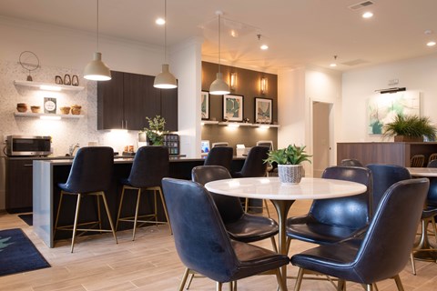 A modern dining area with a round table and chairs.