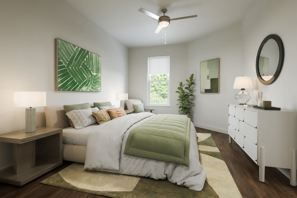 A bedroom with a large bed and a ceiling fan.